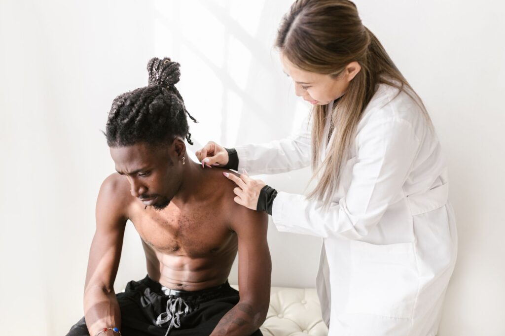 A therapist performs acupuncture on a patient for pain relief in a modern setting, dry needling newnan ga