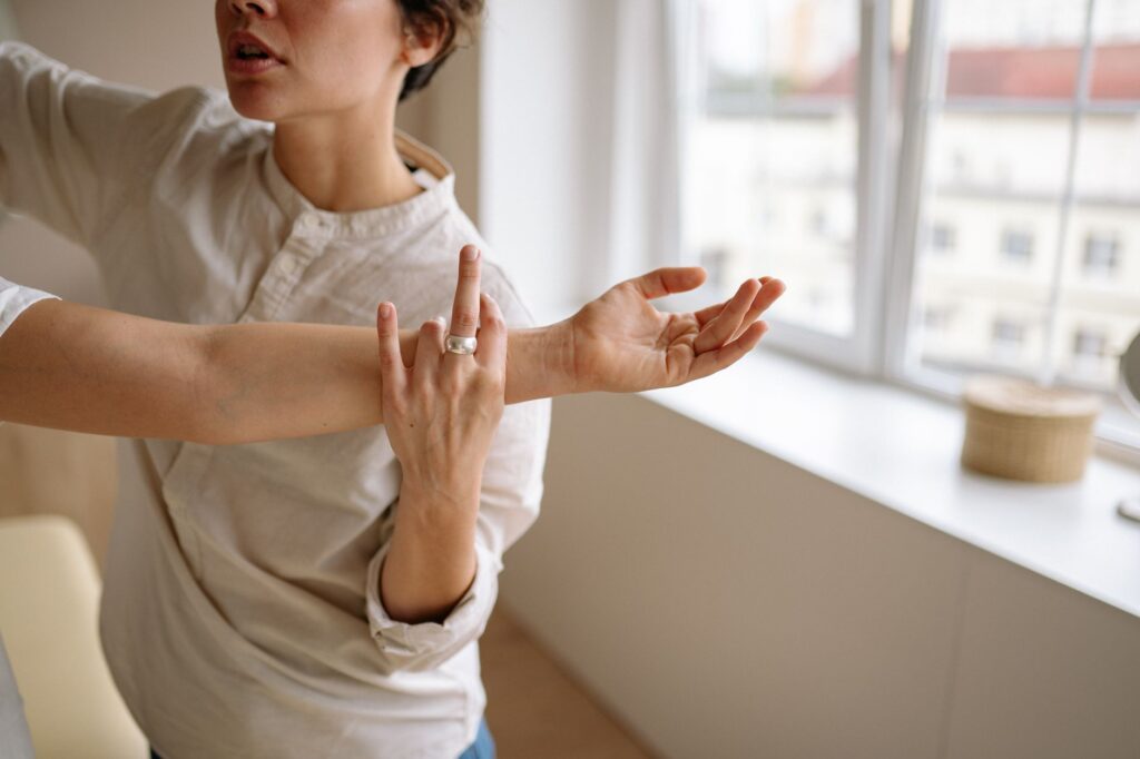 Physical therapist stretches a woman's arm in a sunny room, physical therapist newnan ga